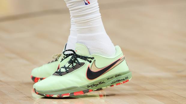 View of green and black Nike LeBron shoes.